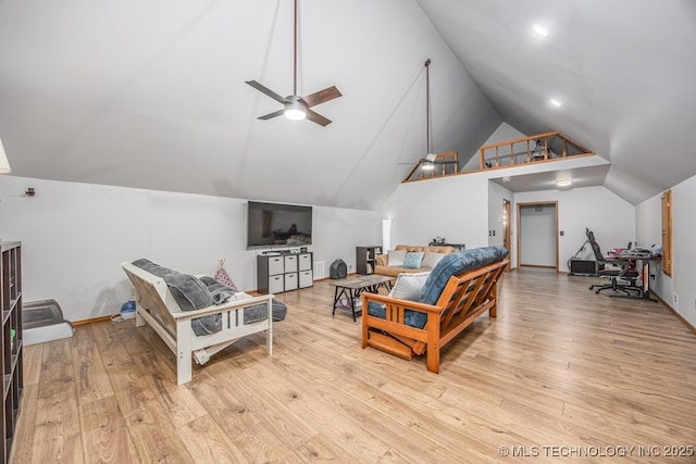 living room with vaulted ceiling, a ceiling fan, and wood finished floors