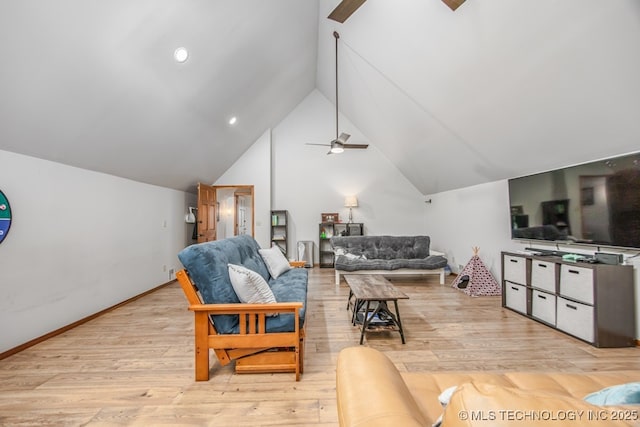 living area featuring light wood finished floors, lofted ceiling, and ceiling fan