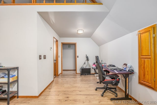 office with light wood-type flooring, baseboards, and lofted ceiling