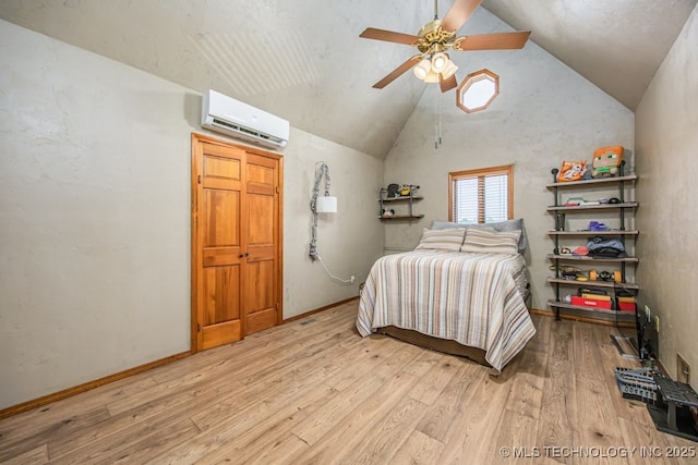 bedroom featuring wood finished floors, a wall mounted air conditioner, ceiling fan, and vaulted ceiling