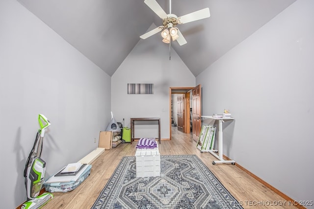 game room featuring wood finished floors, high vaulted ceiling, and a ceiling fan