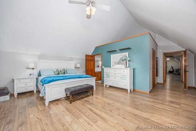 bedroom featuring light wood finished floors, vaulted ceiling, and a ceiling fan
