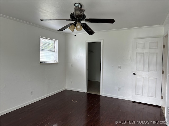 236 Bluebird Ln, Colbert, OK 74733 - unfurnished bedroom with crown molding, a walk in closet, dark wood-style floors, a closet, and a ceiling fan