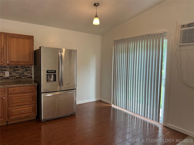 236 Bluebird Ln, Colbert, OK 74733 - kitchen with stainless steel fridge, vaulted ceiling, backsplash, brown cabinets, and dark wood finished floors