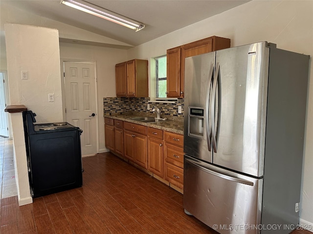 236 Bluebird Ln, Colbert, OK 74733 - kitchen featuring stainless steel fridge with ice dispenser, black electric range, brown cabinetry, vaulted ceiling, and dark wood finished floors
