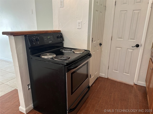 236 Bluebird Ln, Colbert, OK 74733 - kitchen with black range with electric cooktop and wood finished floors