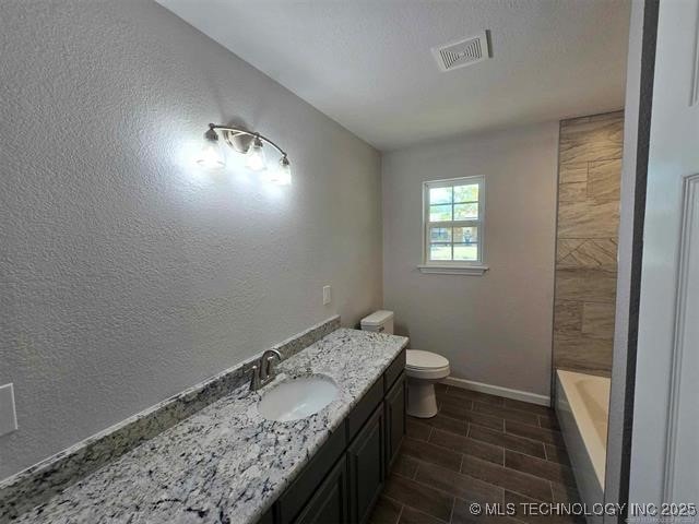bathroom featuring a tub, baseboards, walk in shower, toilet, and visible vents