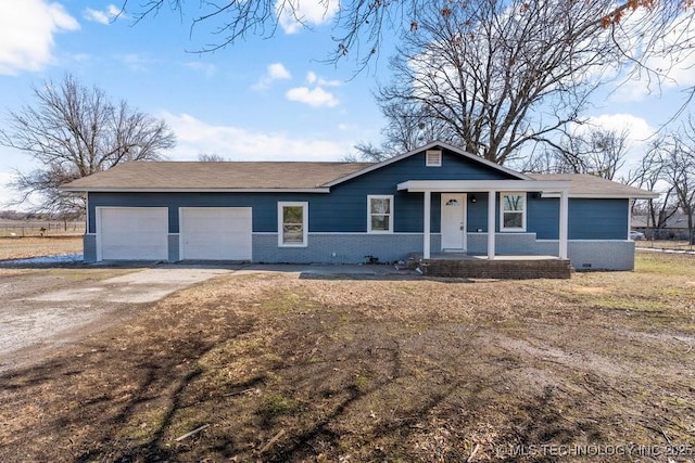 view of front of home featuring an attached garage, roof with shingles, driveway, and brick siding