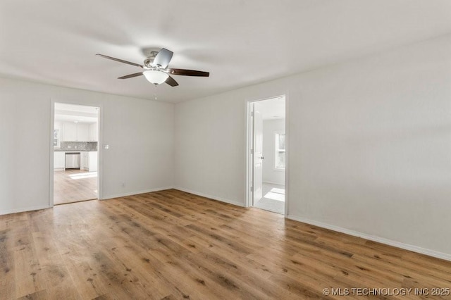 interior space with baseboards, connected bathroom, and wood finished floors