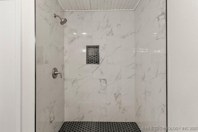 full bath featuring a marble finish shower