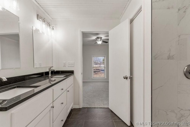 full bath featuring double vanity, baseboards, a sink, and ceiling fan