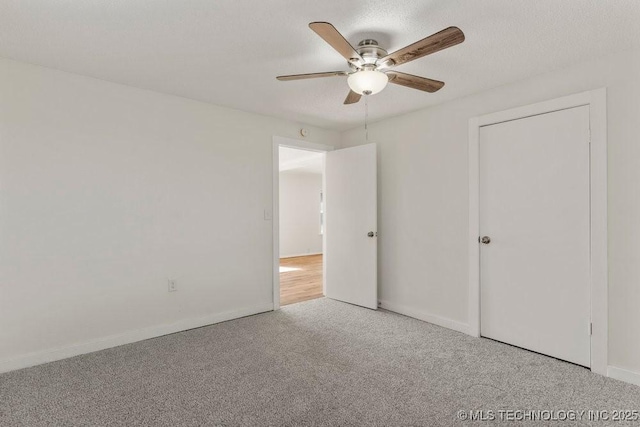 unfurnished bedroom with carpet, baseboards, and ceiling fan