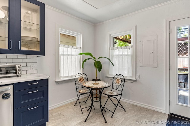 1235 S Atlanta Pl, Tulsa, OK 74104 - dining area with crown molding, a toaster, electric panel, and plenty of natural light