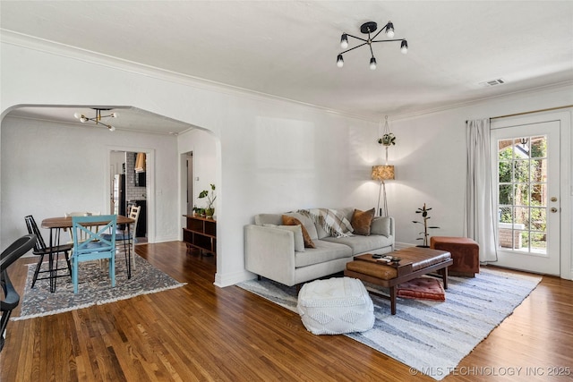 1235 S Atlanta Pl, Tulsa, OK 74104 - living room with arched walkways, wood finished floors, crown molding, and visible vents