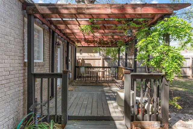 1235 S Atlanta Pl, Tulsa, OK 74104 - deck with outdoor dining space, fence, and a pergola
