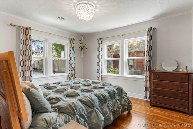 1235 S Atlanta Pl, Tulsa, OK 74104 - bedroom featuring wood finished floors, ornamental molding, and visible vents