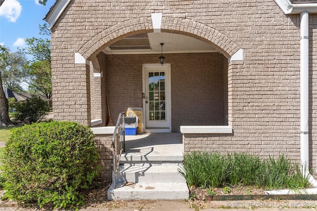 1235 S Atlanta Pl, Tulsa, OK 74104 - view of exterior entry featuring brick siding and covered porch