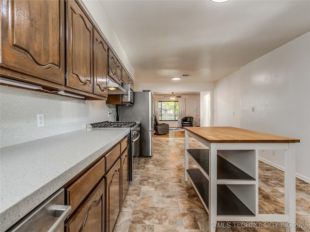 kitchen featuring open shelves, appliances with stainless steel finishes, wood counters, stone finish flooring, and visible vents