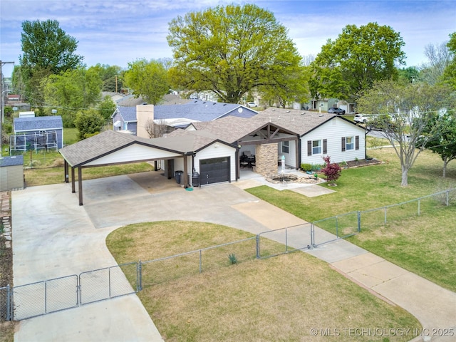 single story home featuring concrete driveway, fence, a gate, and a front yard
