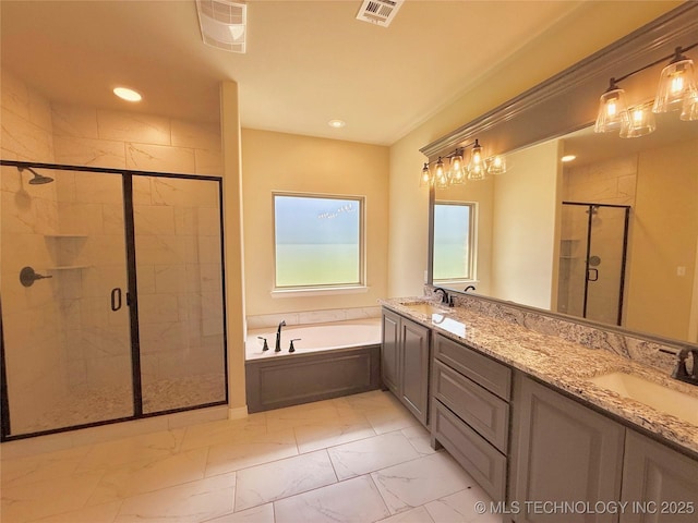 full bathroom with a sink, a shower stall, marble finish floor, visible vents, and a garden tub