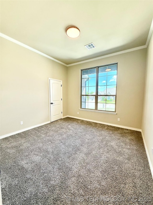 spare room featuring crown molding, visible vents, and carpet