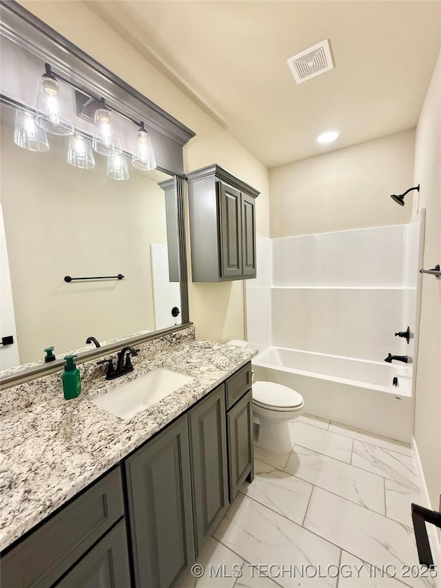 bathroom with vanity, toilet, marble finish floor, visible vents, and baseboards