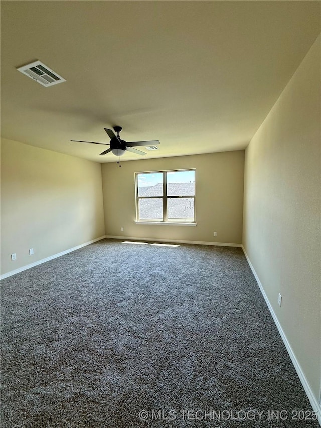 carpeted spare room featuring visible vents, ceiling fan, and baseboards