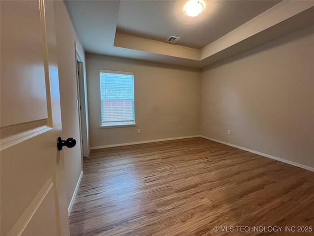 6370 E 124th Ct, Bixby, OK 74008 - unfurnished room with a raised ceiling and wood finished floors