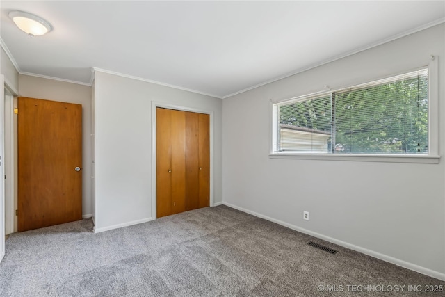 5656 S Zunis Ave, Tulsa, OK 74105 - unfurnished bedroom with carpet, baseboards, a closet, and ornamental molding