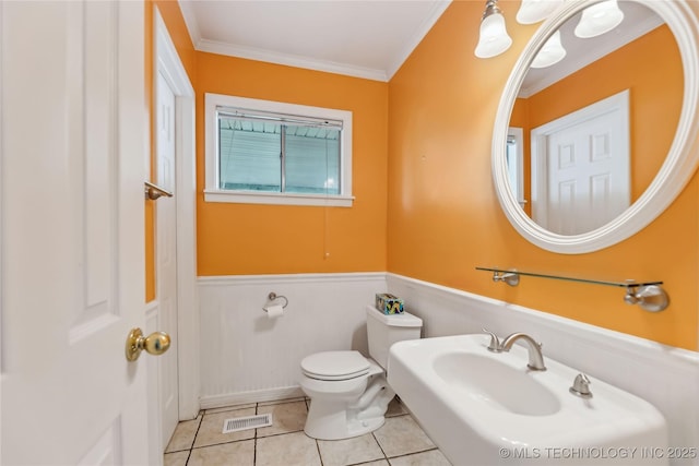 5656 S Zunis Ave, Tulsa, OK 74105 - bathroom with a wainscoted wall, toilet, tile patterned flooring, crown molding, and a sink