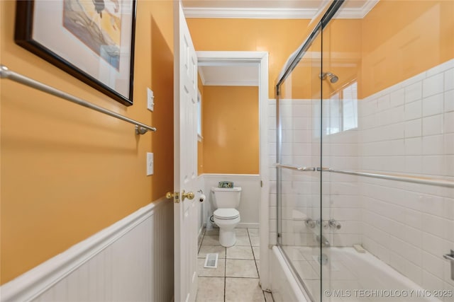 5656 S Zunis Ave, Tulsa, OK 74105 - bathroom with toilet, combined bath / shower with glass door, wainscoting, tile patterned floors, and crown molding