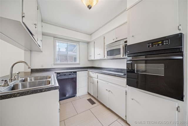 5656 S Zunis Ave, Tulsa, OK 74105 - kitchen with black appliances, a sink, white cabinetry, dark countertops, and light tile patterned flooring