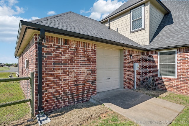 6199 E 144th St N, Collinsville, OK 74021 - view of side of property featuring a garage, a shingled roof, and brick siding