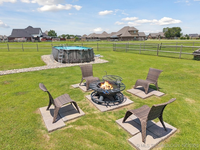 6199 E 144th St N, Collinsville, OK 74021 - fenced yard featuring a fire pit and a residential view