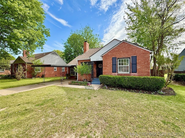 single story home with driveway, a front lawn, and brick siding