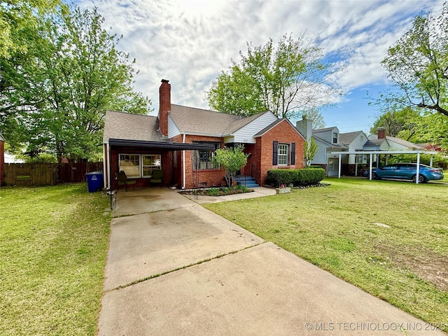 view of front of house with concrete driveway, brick siding, fence, and a front lawn