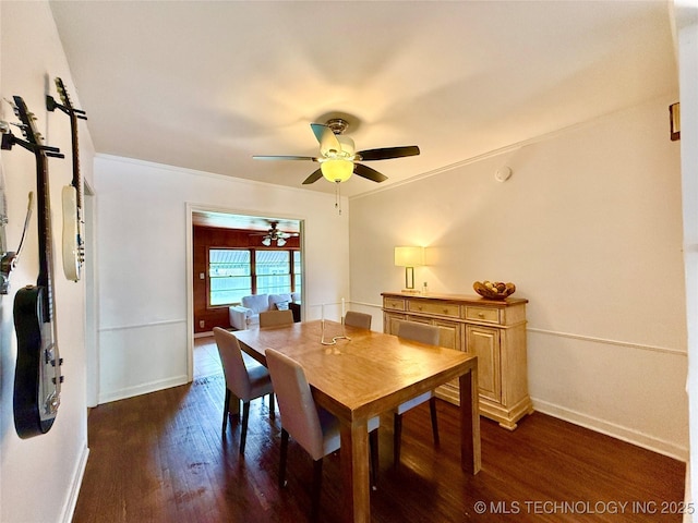 dining space with ornamental molding, ceiling fan, baseboards, and dark wood-style floors
