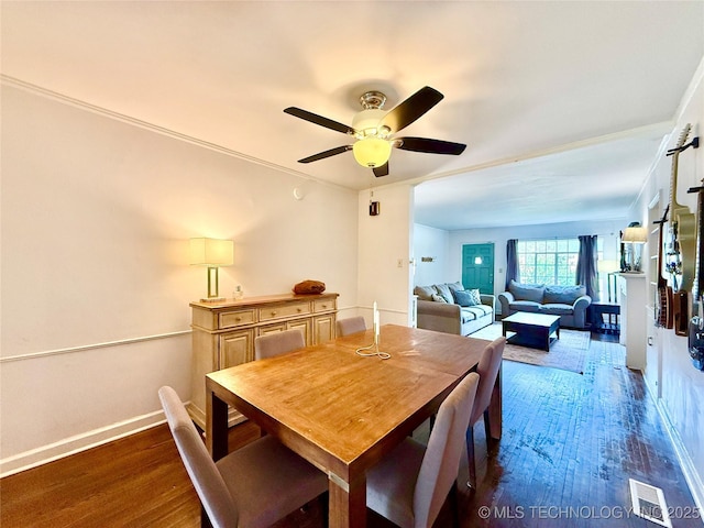 dining space with baseboards, dark wood-style flooring, visible vents, and a ceiling fan