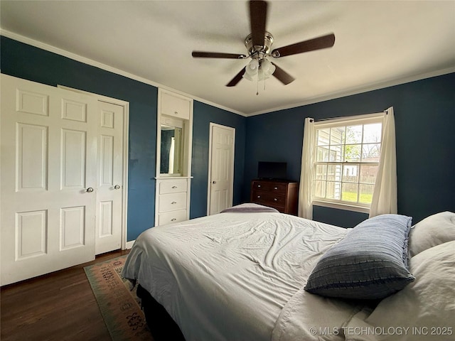 bedroom featuring crown molding, a ceiling fan, and dark wood finished floors