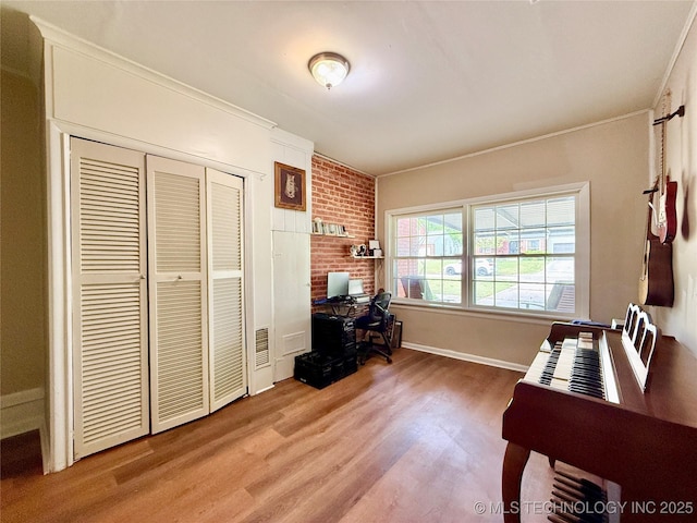 office space with wood finished floors, baseboards, and visible vents