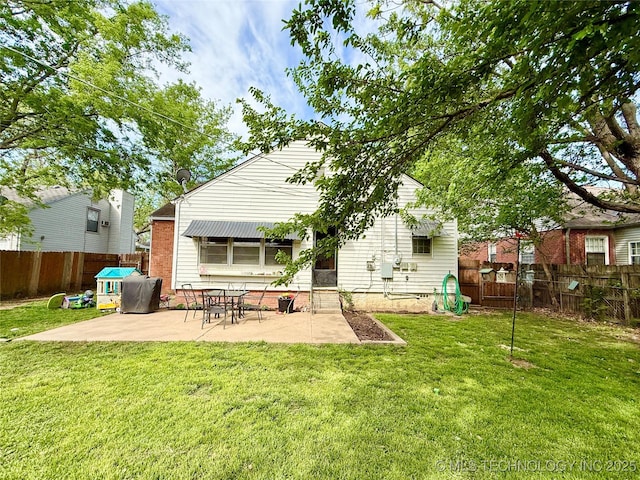 back of property featuring a fenced backyard, a patio, and a lawn