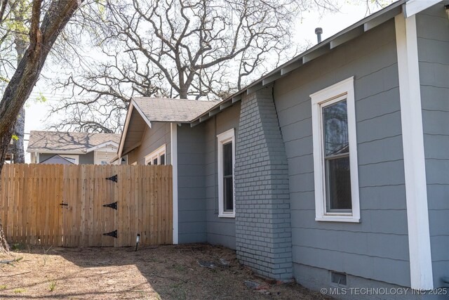 511 N Main St, Sand Springs, OK 74063 - view of home's exterior featuring fence, crawl space, and brick siding