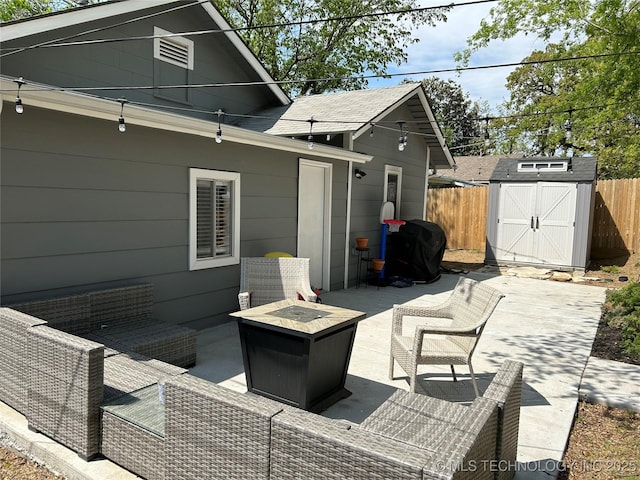 511 N Main St, Sand Springs, OK 74063 - view of patio featuring an outdoor living space with a fire pit, fence, a storage shed, and an outbuilding