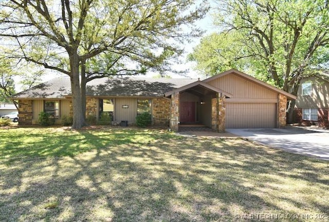 single story home featuring a front lawn, a garage, and concrete driveway