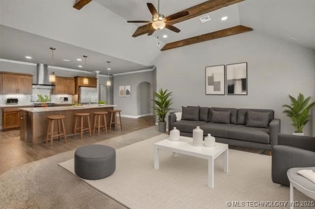 11439 N 162nd E Ave, Owasso, OK 74055 - living room featuring a ceiling fan, recessed lighting, beam ceiling, light wood-style flooring, and arched walkways