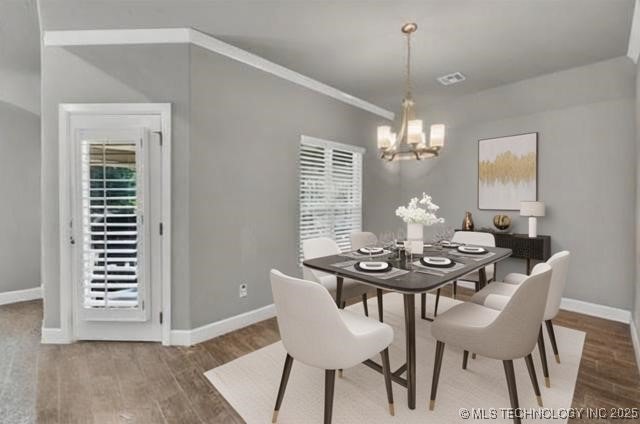 11439 N 162nd E Ave, Owasso, OK 74055 - dining area featuring a chandelier, wood finished floors, and baseboards