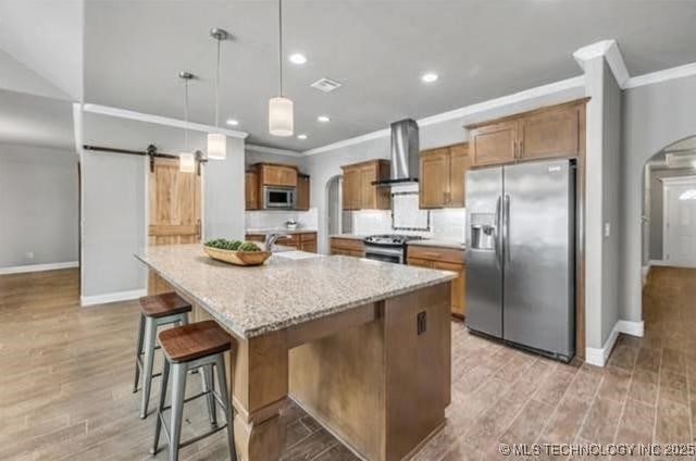 11439 N 162nd E Ave, Owasso, OK 74055 - kitchen featuring appliances with stainless steel finishes, wall chimney exhaust hood, arched walkways, ornamental molding, and brown cabinets