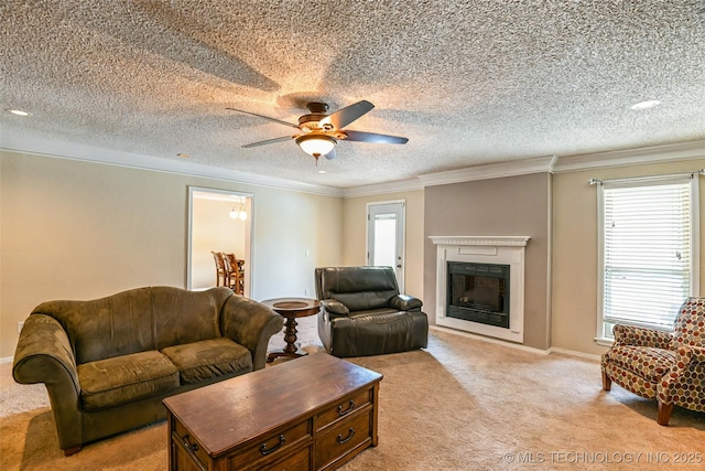 living room featuring light colored carpet, ceiling fan, ornamental molding, and plenty of natural light