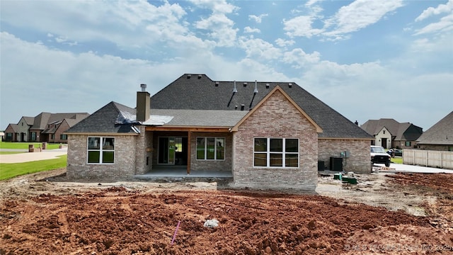 17806 S 46 E Ave, Bixby, OK 74008 - rear view of property featuring a patio, a chimney, brick siding, roof with shingles, and a residential view