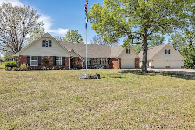 view of front facade with brick siding, a front lawn, driveway, and roof with shingles